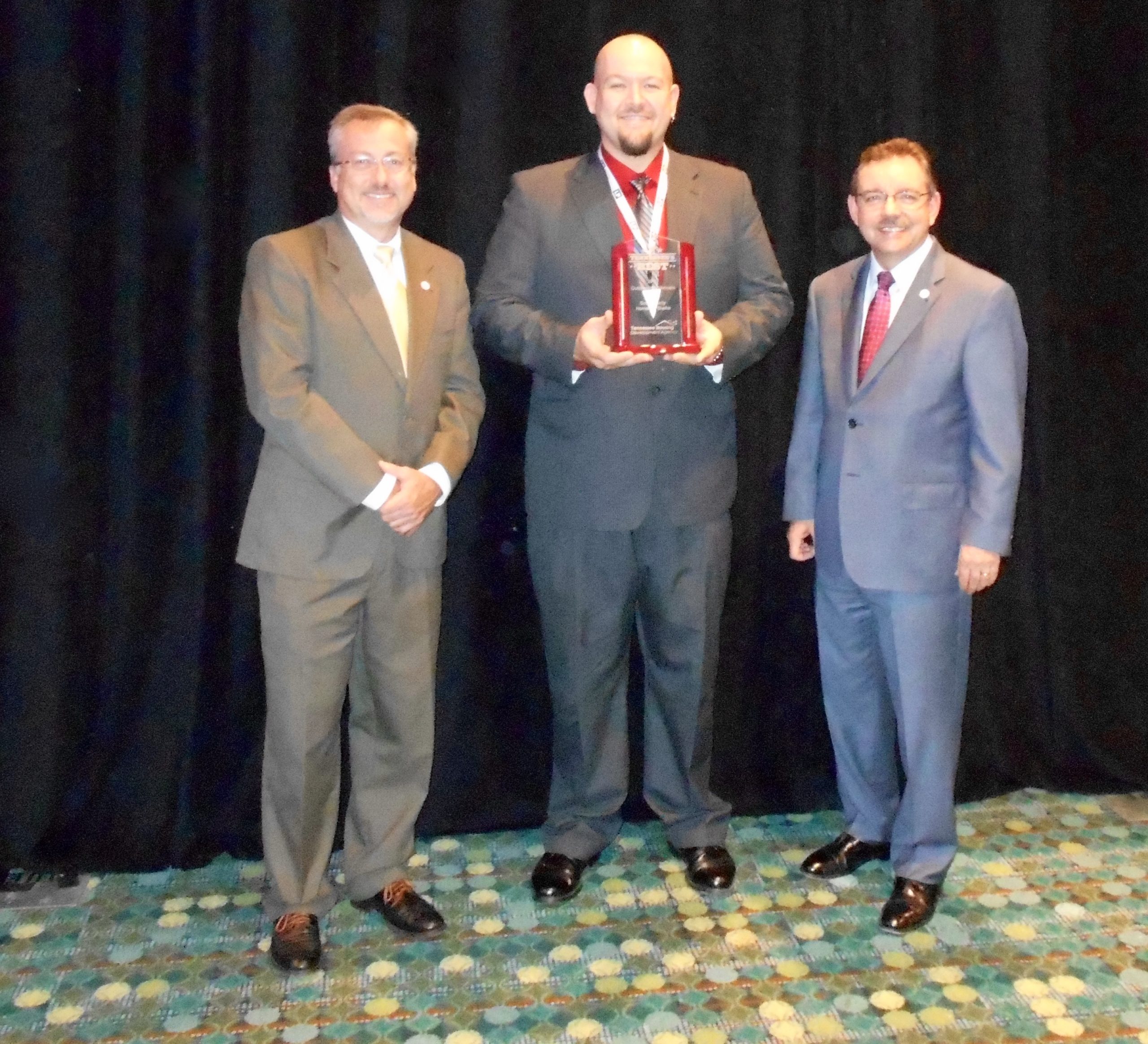 Ray Perry, executive director of pinnacle resource center, accepting an award in 2015